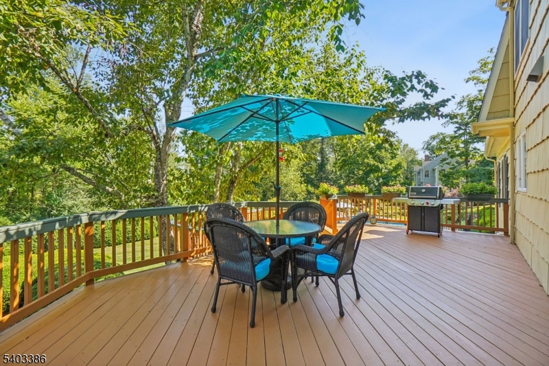 80 Spring Valley Road Morristown, NJ 07960 - Photo 12 of 48 a view of a roof deck with table and chairs under an umbrella with wooden floor