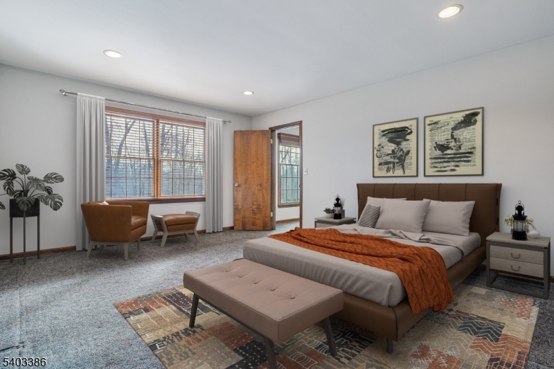 80 Spring Valley Road Morristown, NJ 07960 - Photo 17 of 48 a spacious bedroom with a bed and a couch