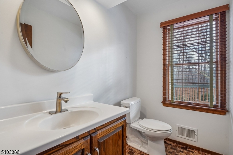 80 Spring Valley Road Morristown, NJ 07960 - Photo 18 of 48 a bathroom with a sink a toilet and a mirror