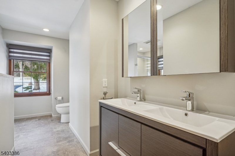 80 Spring Valley Road Morristown, NJ 07960 - Photo 30 of 48 a bathroom with a double vanity sink and a toilet