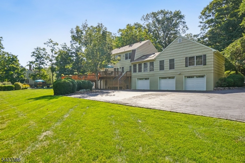 80 Spring Valley Road Morristown, NJ 07960 - Photo 47 of 48 a front view of a house with a garden and trees