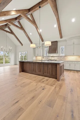 a large en suite bathroom with a granite countertop sink mirror and shower