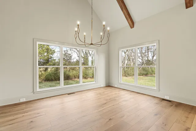 a view of an empty room and window and washer and dryer