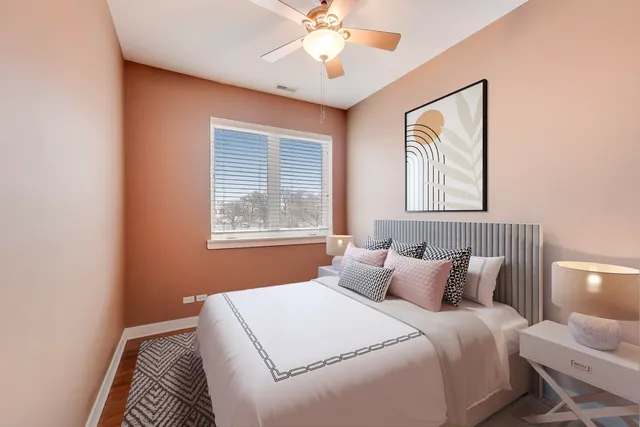 an empty room with a window and a ceiling fan