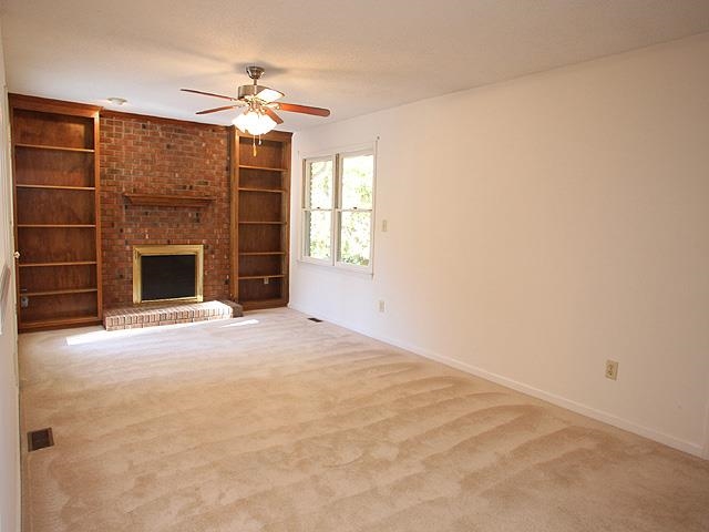 152 Stagecrest Drive Raleigh, NC 27603 - Photo 3 of 14 an empty room with a fireplace and windows