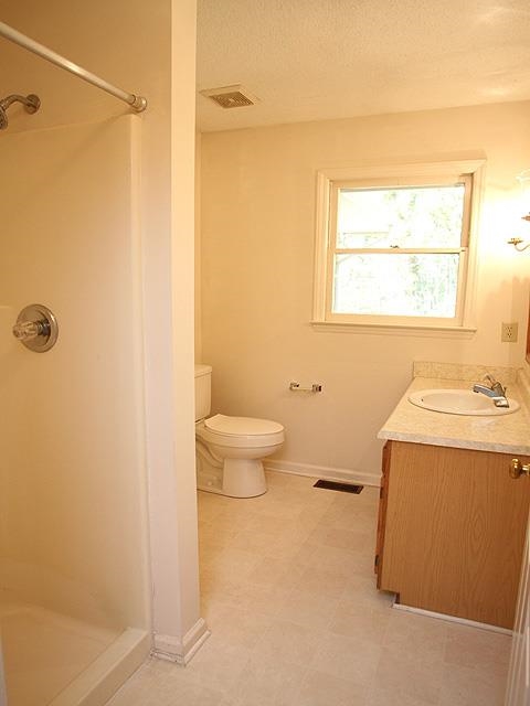 152 Stagecrest Drive Raleigh, NC 27603 - Photo 8 of 14 a bathroom with a granite countertop sink toilet and shower