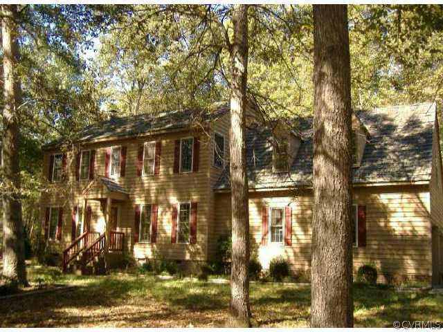 a view of a brick house with a yard