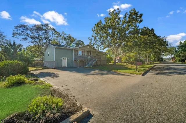 a view of a house with a yard and garage