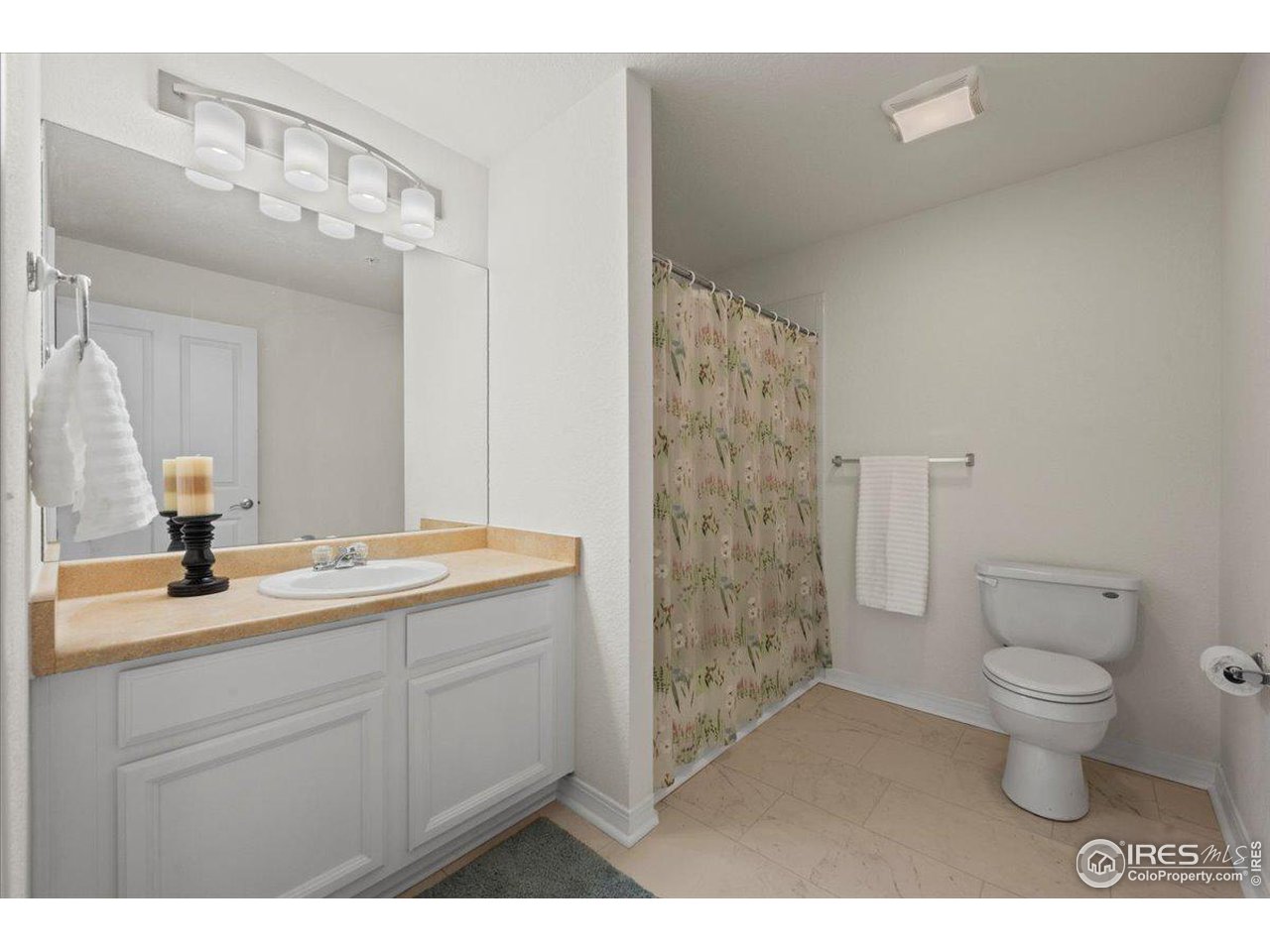 2133 Krisron Road, Unit 101 Fort Collins, CO 80525 - Photo 18 of 22 a bathroom with a granite countertop sink a toilet and a mirror