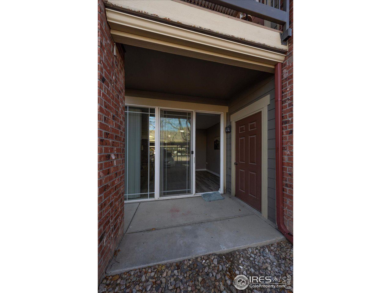 2133 Krisron Road, Unit 101 Fort Collins, CO 80525 - Photo 19 of 22 a picture of a room that has a door and a rug