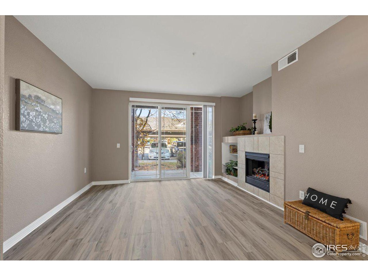 2133 Krisron Road, Unit 101 Fort Collins, CO 80525 - Photo 5 of 22 a view of an empty room with a fireplace and a window