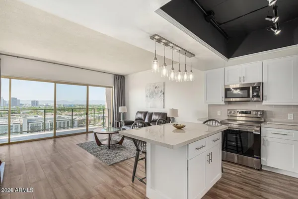 a kitchen with stainless steel appliances granite countertop a sink stove and wooden cabinets