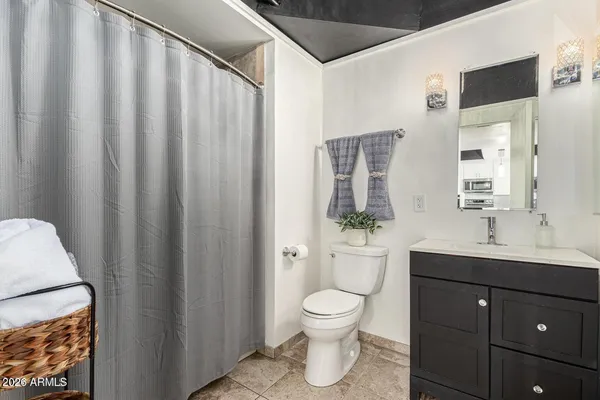 a bathroom with a toilet a sink and a mirror