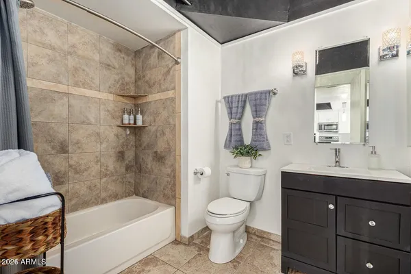 a bathroom with a sink a toilet and bathtub