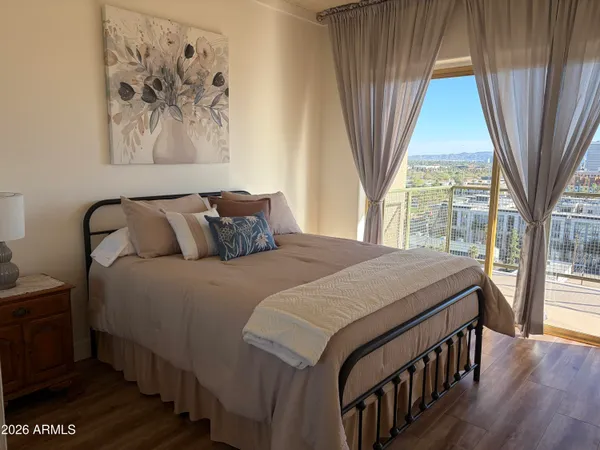 a bedroom with a bed and a large window