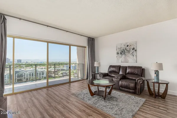 a living room with furniture and a floor to ceiling window
