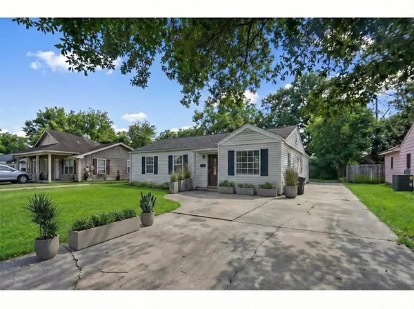 a front view of a house with a garden