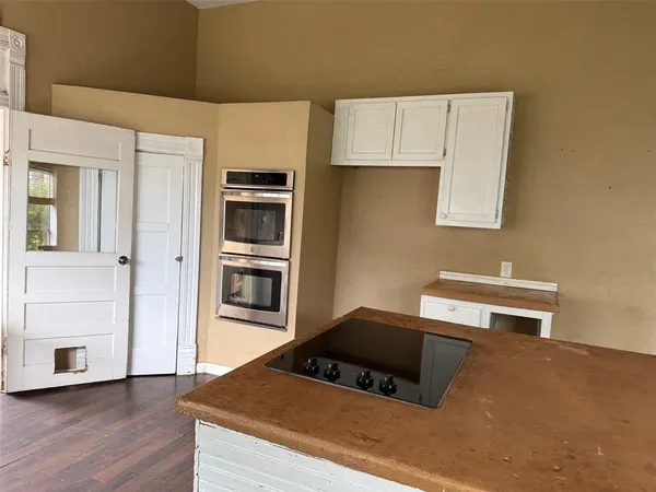 a kitchen with kitchen island a counter top space and stainless steel appliances