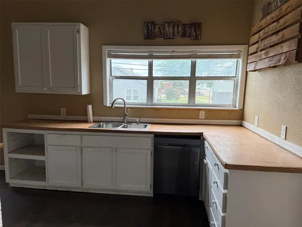 a kitchen with a sink and a window
