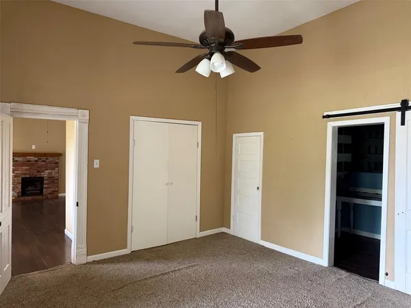 an empty room and chandelier fan