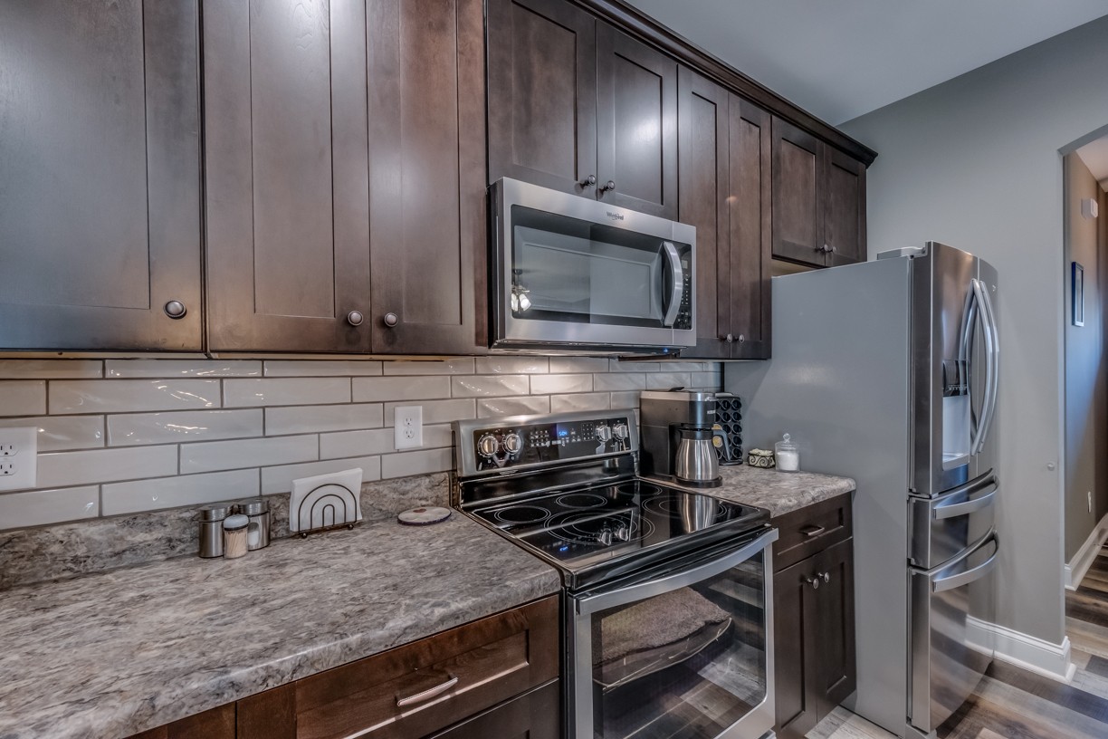 148 A T G T Road Portland, TN 37148 - Photo 15 of 30 a kitchen with granite countertop stainless steel appliances and wooden cabinets