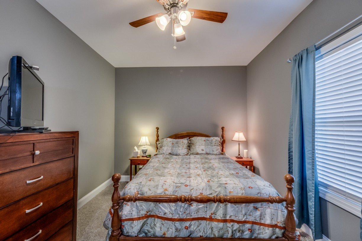 148 A T G T Road Portland, TN 37148 - Photo 22 of 30 a bedroom with a bed and a chandelier
