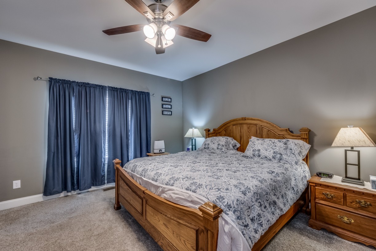 148 A T G T Road Portland, TN 37148 - Photo 24 of 30 a bedroom with a bed and a chandelier