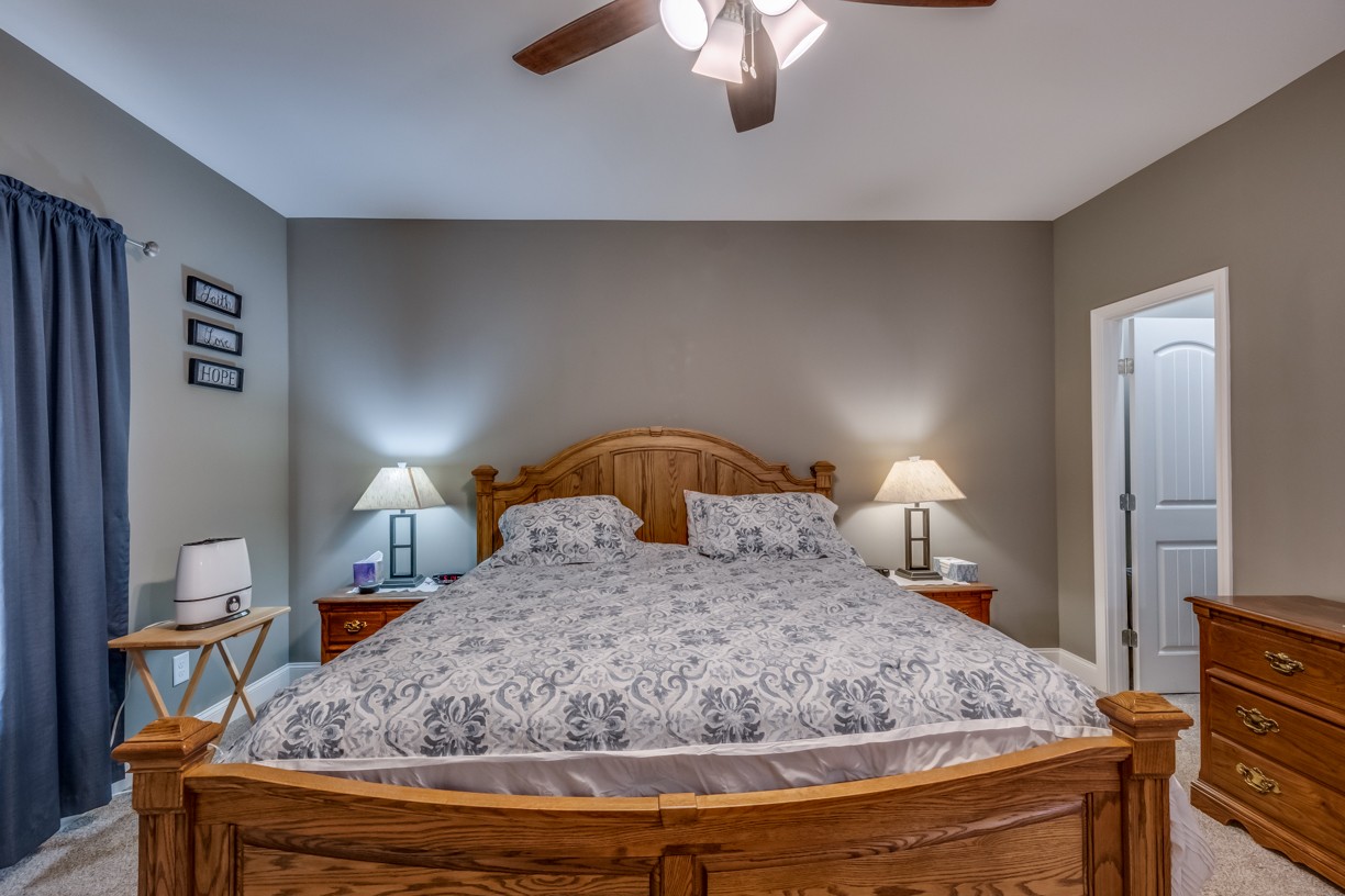 148 A T G T Road Portland, TN 37148 - Photo 25 of 30 a bedroom with a bed and a chandelier
