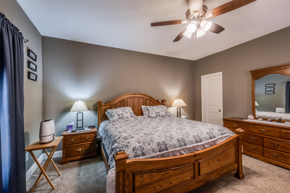 148 A T G T Road Portland, TN 37148 - Photo 26 of 30 a bedroom with a bed and a chandelier