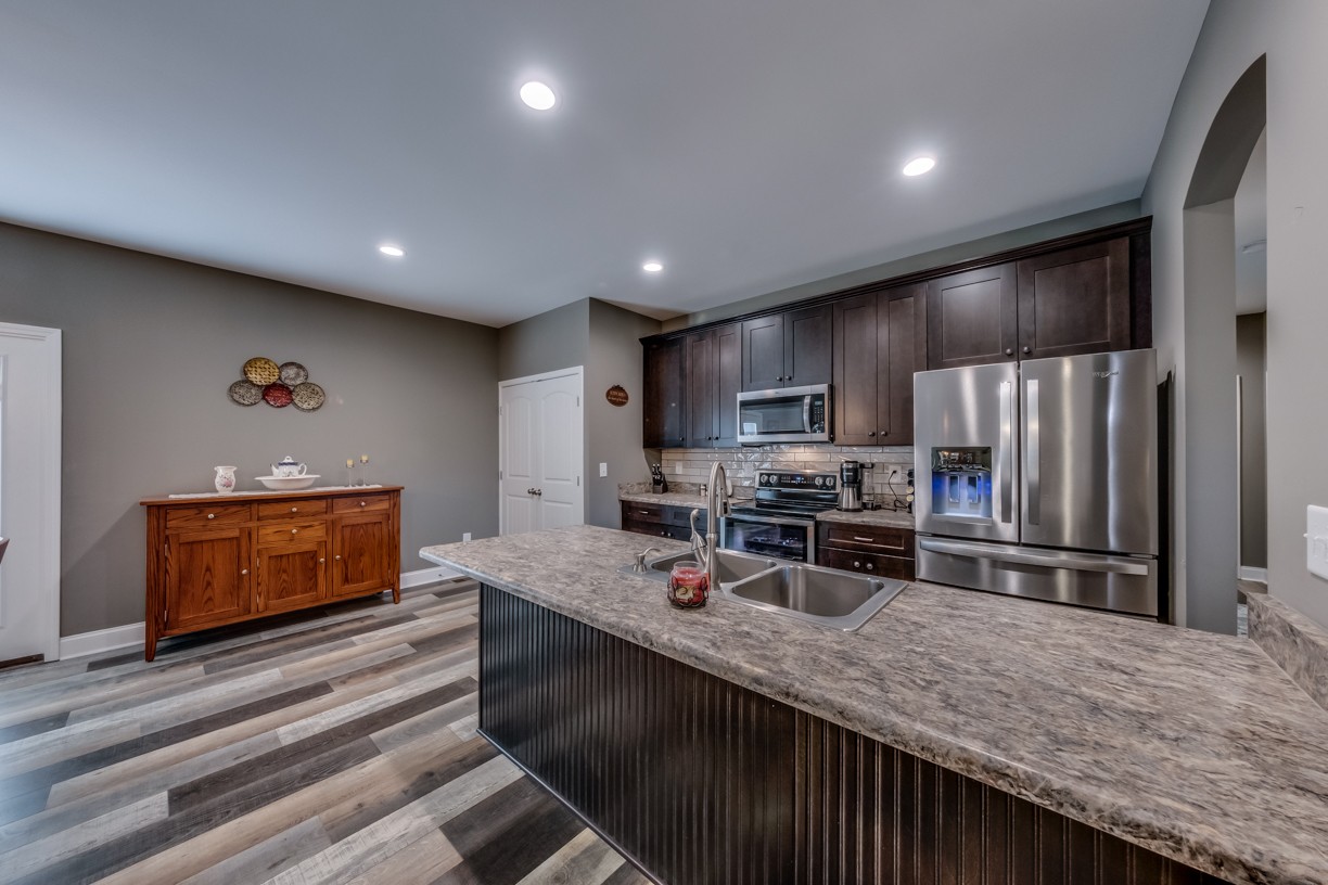 148 A T G T Road Portland, TN 37148 - Photo 10 of 30 a large kitchen with kitchen island a large counter top stainless steel appliances and cabinets