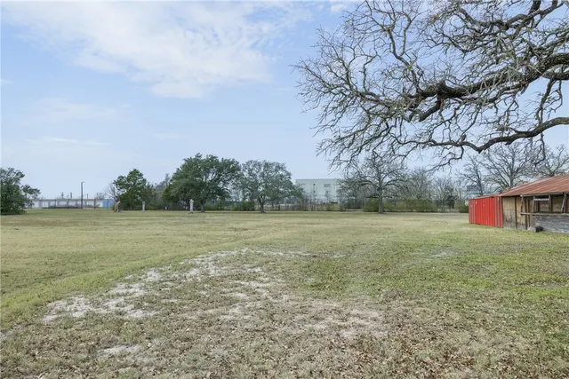 an aerial view of a houses with a yard
