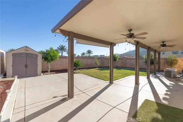 a view of a house with a yard and sitting area