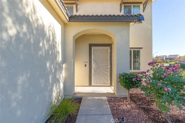 a view of a hallway with wooden floor and closet
