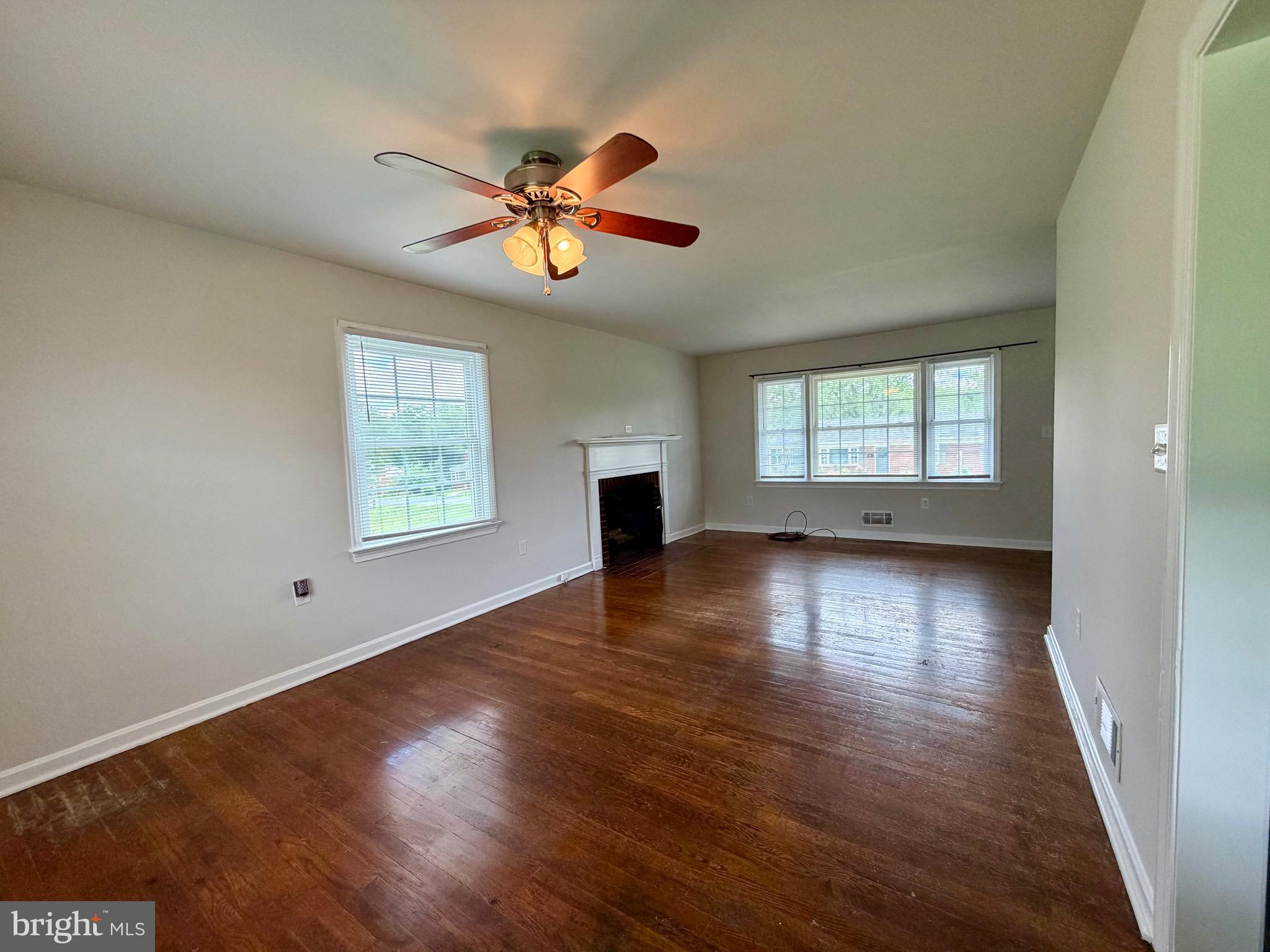 1010 Nottingham Street Culpeper, VA 22701 - Photo 16 of 21 an empty room with wooden floor chandelier fan and windows