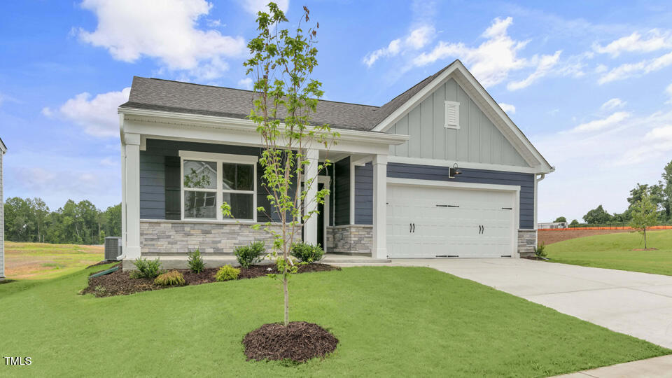 806 Comice Pear Way Willow Spring, NC 27592 - Photo 2 of 37 a front view of a house with a yard