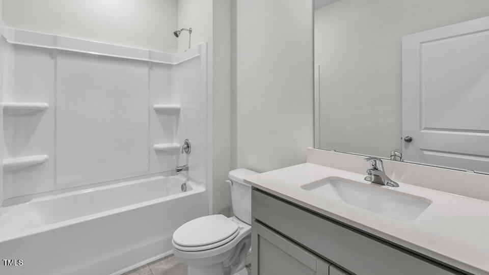 806 Comice Pear Way Willow Spring, NC 27592 - Photo 27 of 37 a bathroom with a sink a toilet and a bathtub