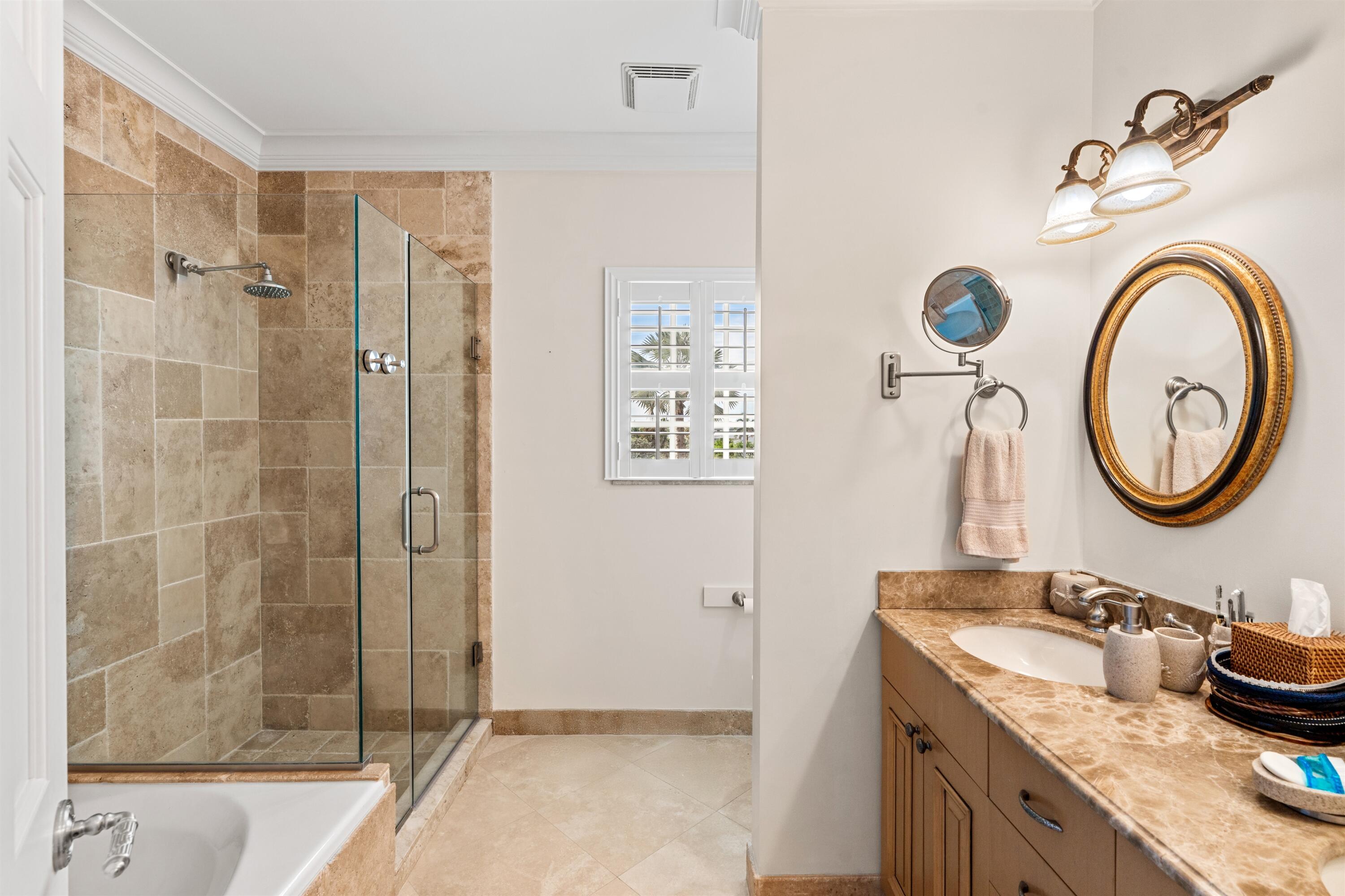 5900 Old Ocean Boulevard, Unit B5 Ocean Ridge, FL 33435 - Photo 11 of 21 a bathroom with a granite countertop sink and a mirror