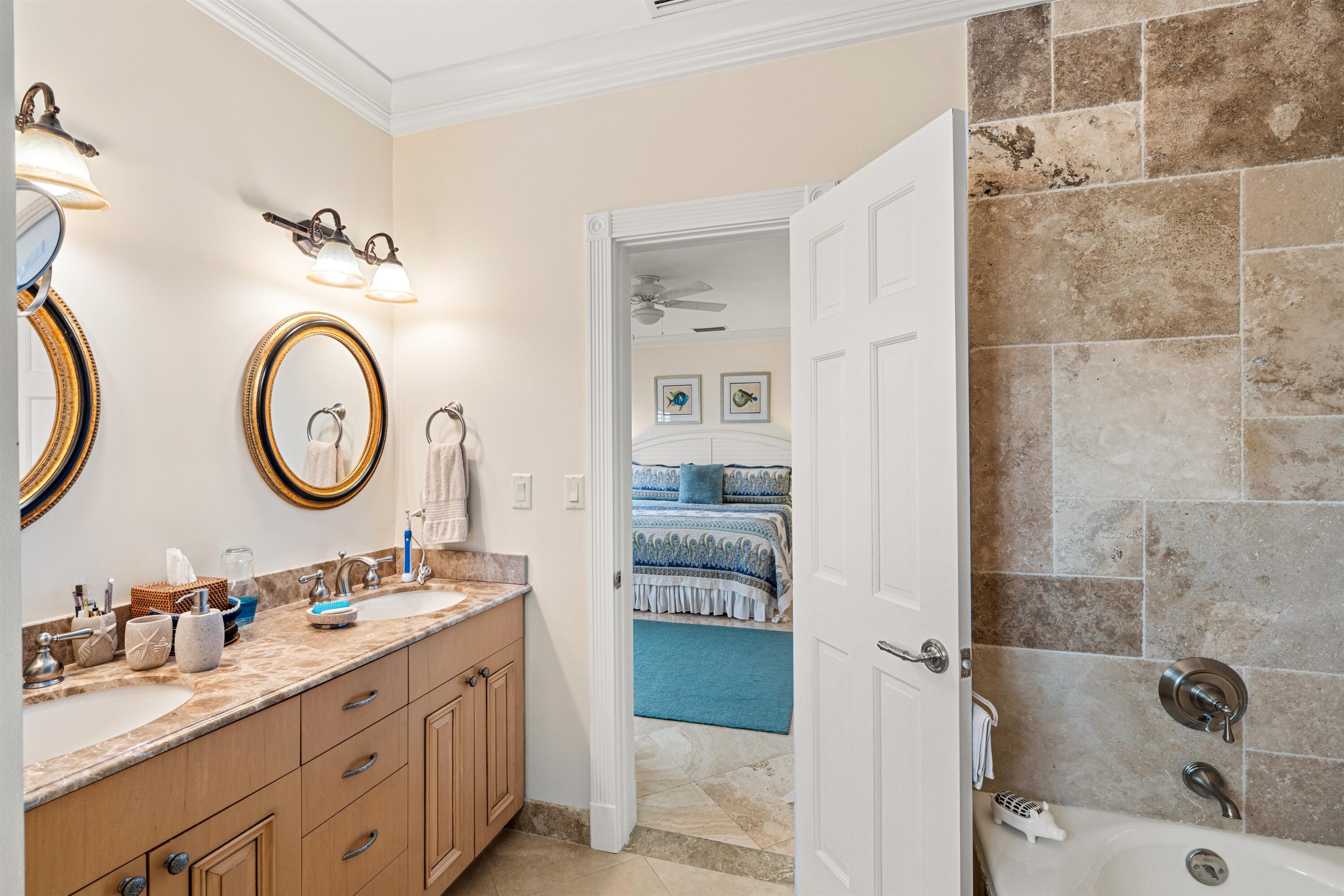 5900 Old Ocean Boulevard, Unit B5 Ocean Ridge, FL 33435 - Photo 12 of 21 a bathroom with a double vanity sink mirror and shower
