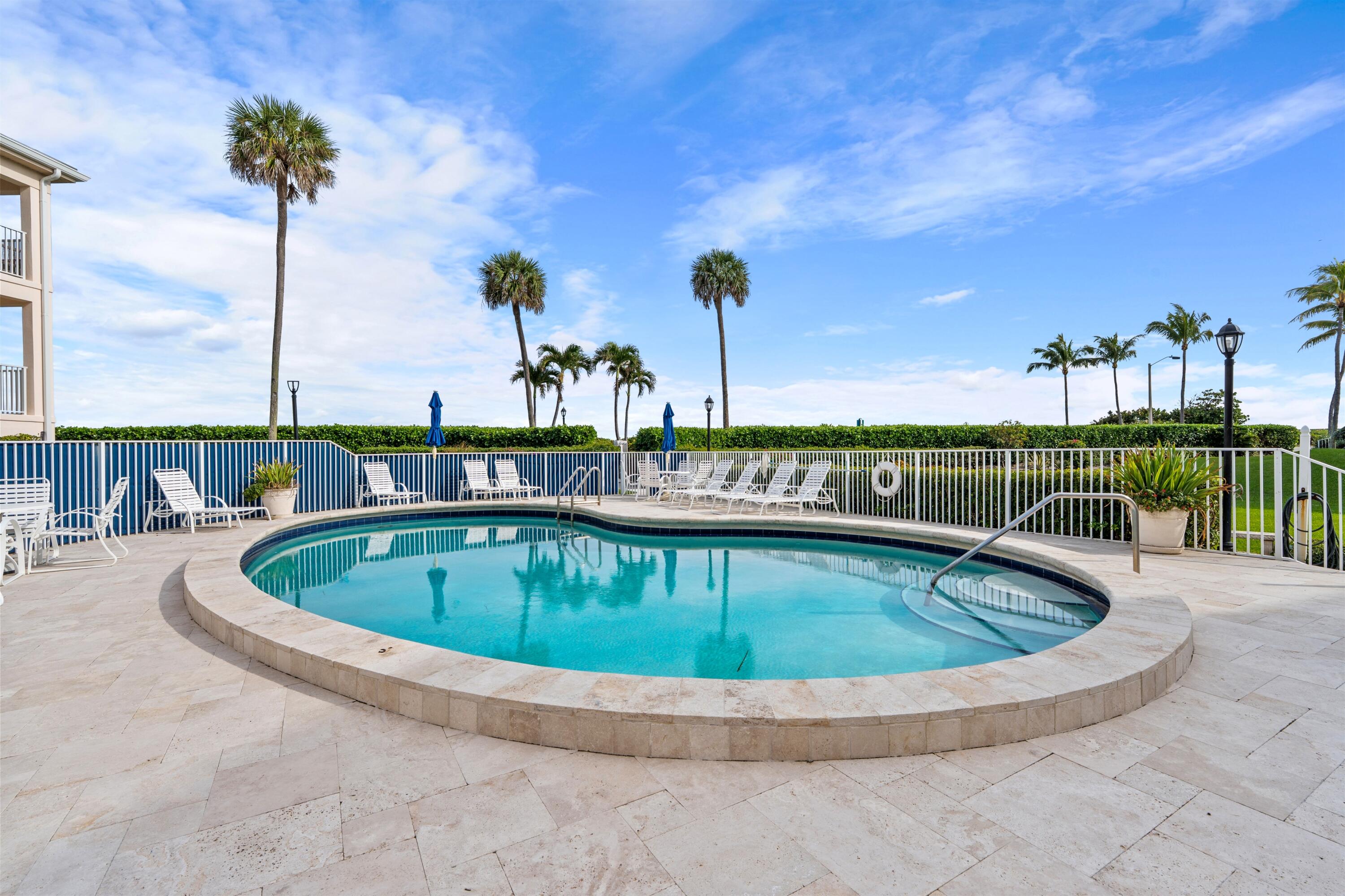 5900 Old Ocean Boulevard, Unit B5 Ocean Ridge, FL 33435 - Photo 18 of 21 a view of a swimming pool with a lounge chair