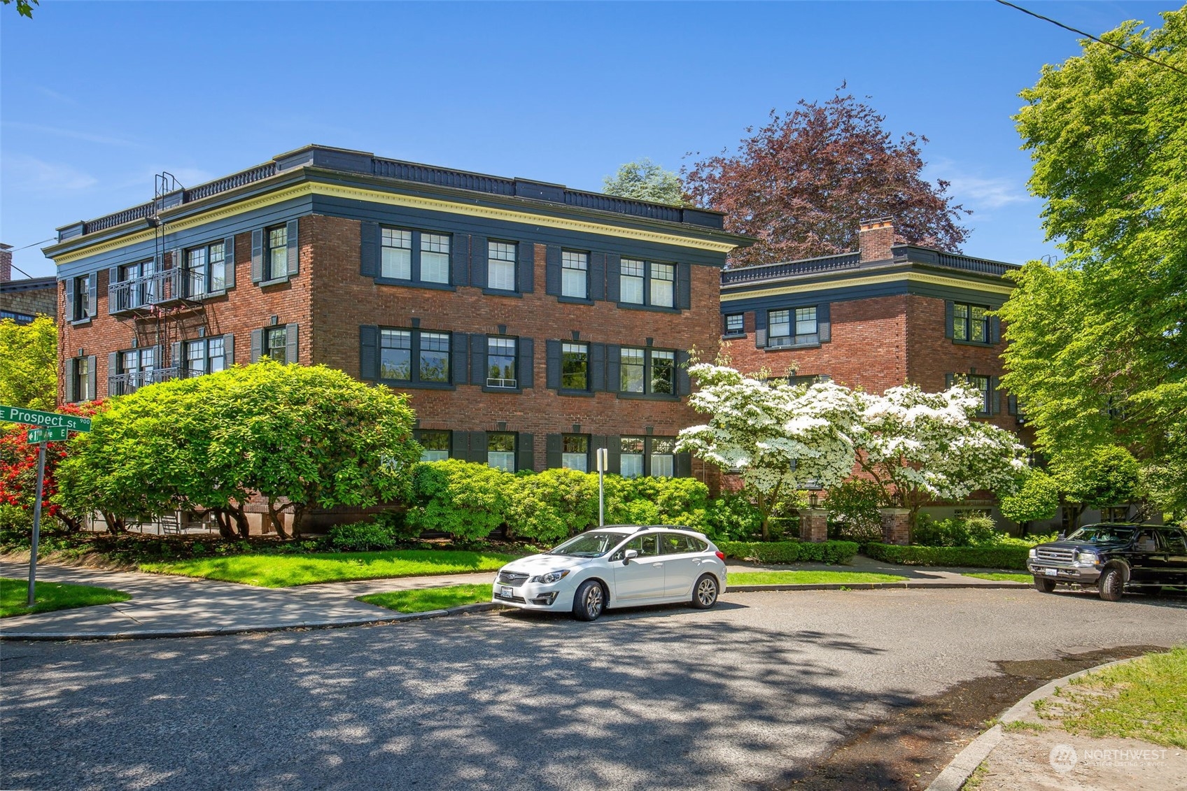 1065 East Prospect Street, Unit 204 Seattle, WA 98102 - Photo 25 of 30 a view of a big house with a yard and plants