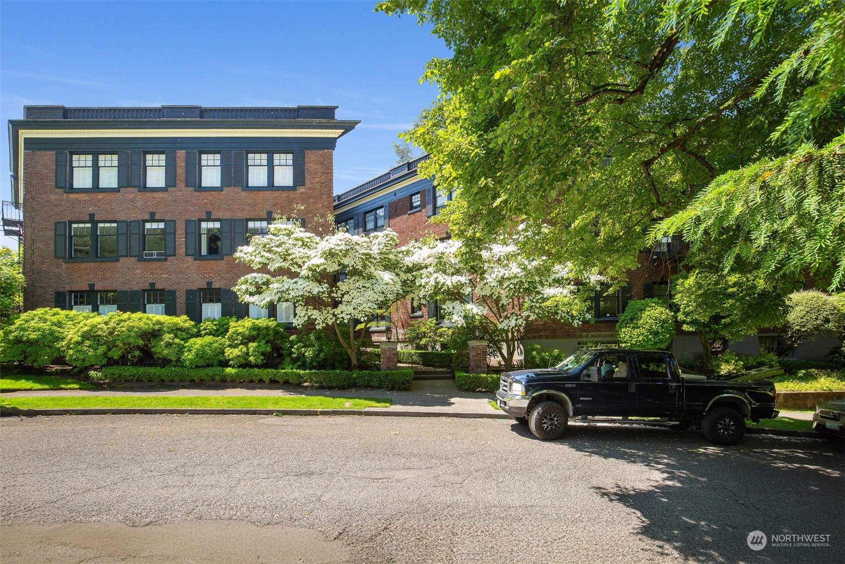 1065 East Prospect Street, Unit 204 Seattle, WA 98102 - Photo 26 of 30 a view of a car is parked in front of a brick house