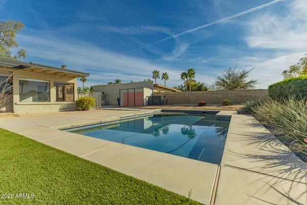 a view of a swimming pool with an outdoor seating