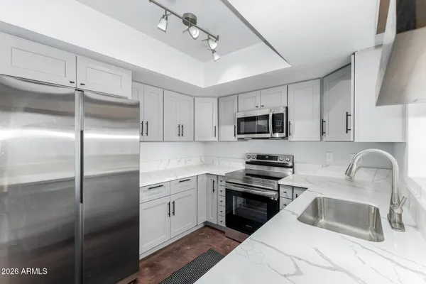 a kitchen with a refrigerator stove and sink