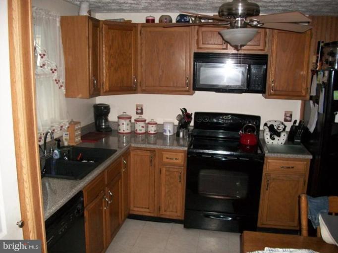 18 Days End Court Rosedale, MD 21237 - Photo 2 of 12 a kitchen with a sink and cabinets