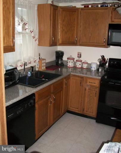 18 Days End Court Rosedale, MD 21237 - Photo 3 of 12 a kitchen with a sink and cabinets