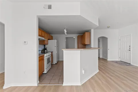 a view of living room with furniture and wooden floor