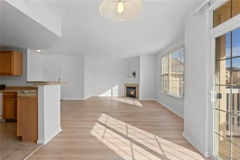 a view of a kitchen with wooden floor and a sink