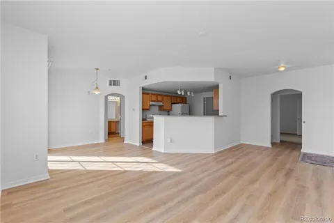 a view of a kitchen with a sink and a refrigerator