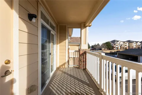 a view of a balcony with wooden floor