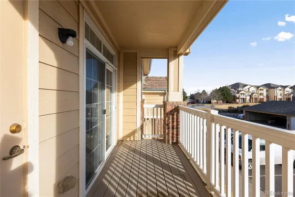 a view of a balcony with wooden floor